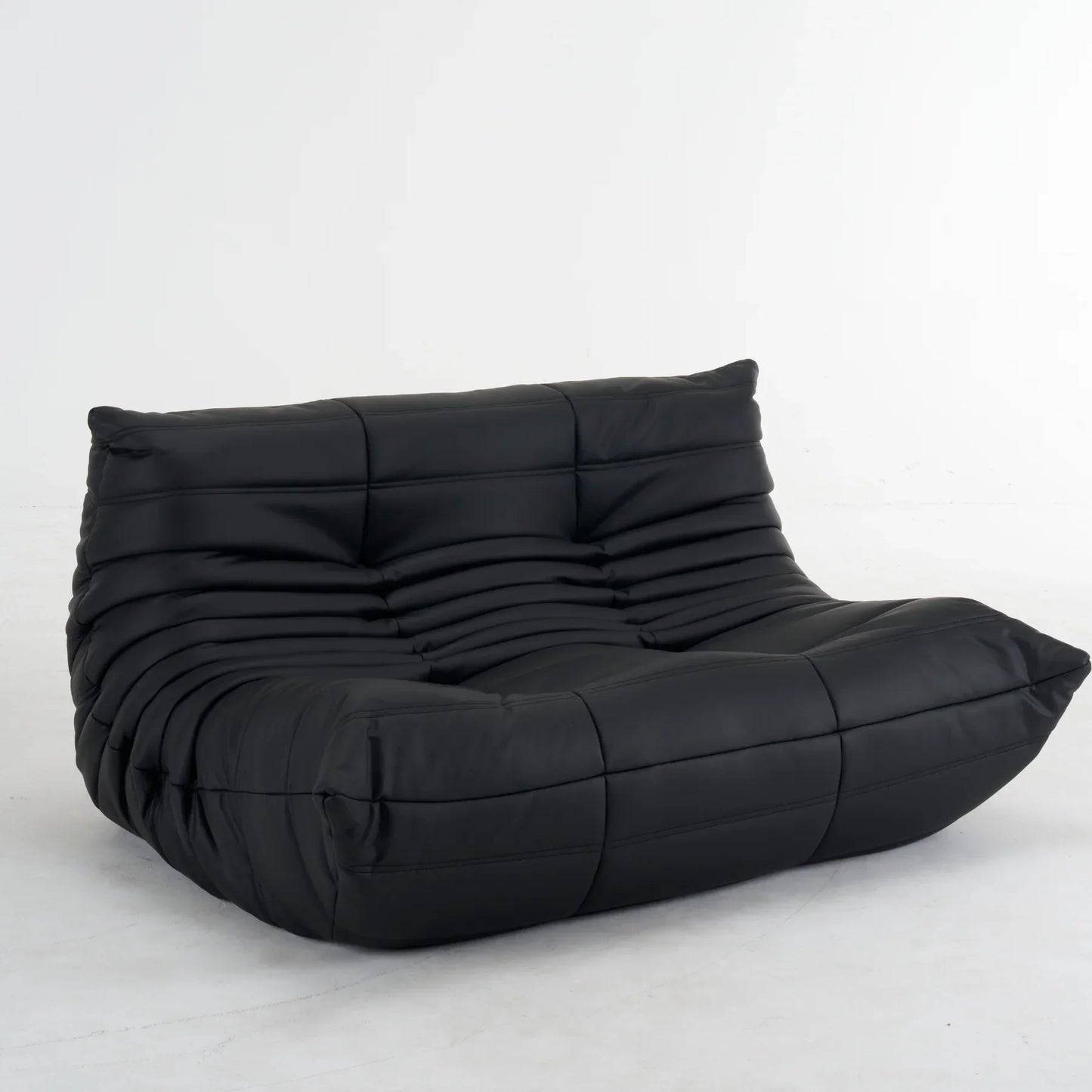 Plush leather loveseat sofa in dark blue with low-profile design and deep plush cushions
