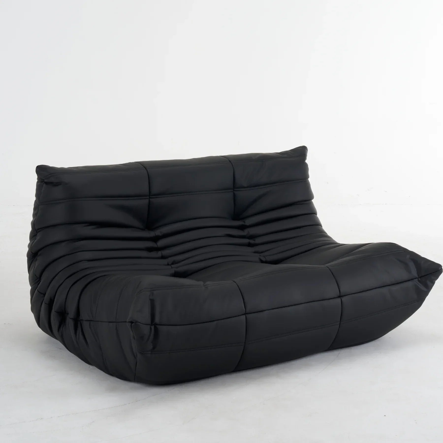 Plush leather loveseat sofa in dark blue with low-profile design and deep plush cushions