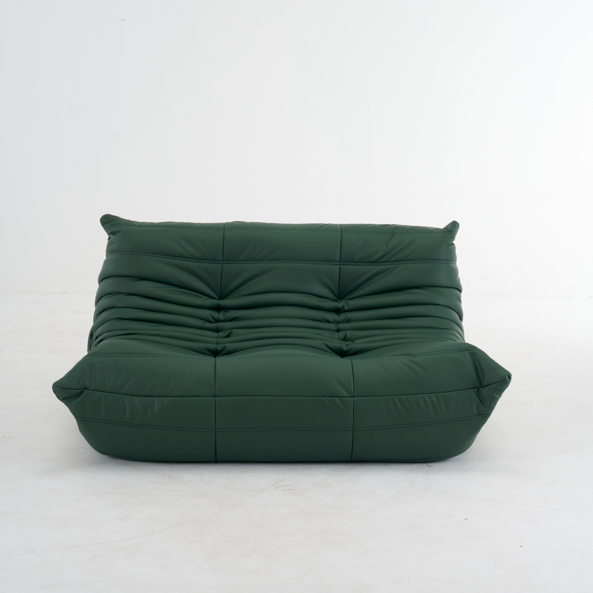 Plush leather loveseat sofa in dark blue with low-profile design and plush cushions
