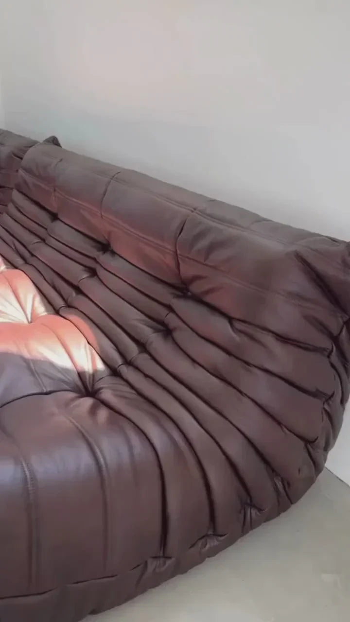 Plush leather loveseat sofa in low-profile design with deep cushions and premium upholstery